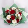 Strauß aus roten Rosen, weißen Gerbera und Schleierkraut.